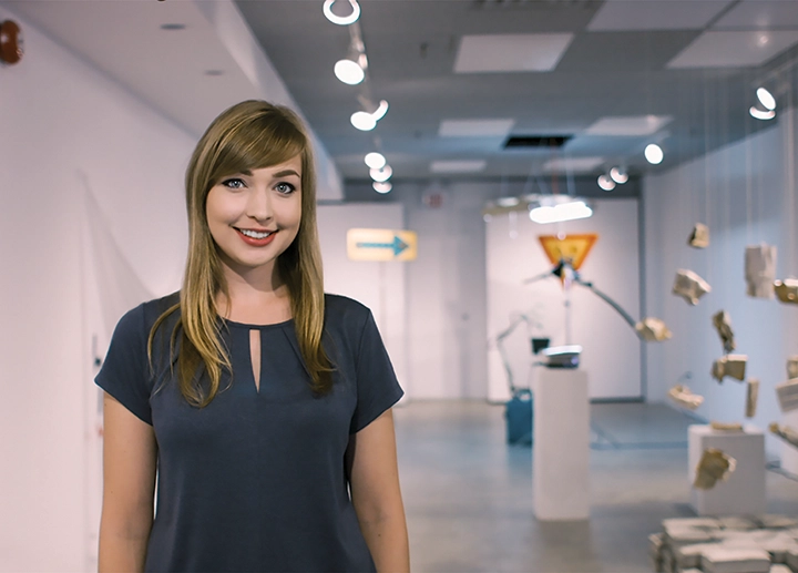 Image of a student in front of the Visual Arts Building Art Gallery
