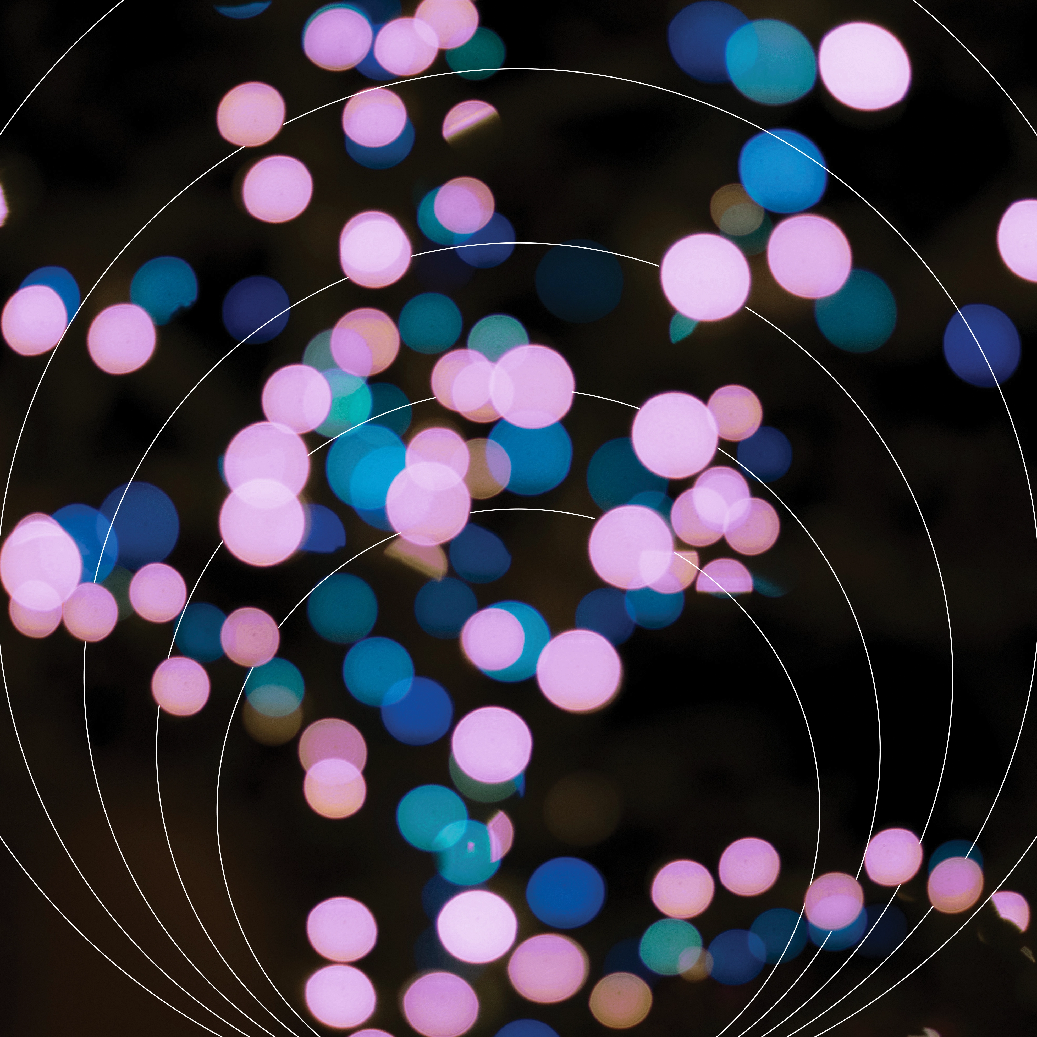 blue, pink and purple spotlights in front of concentric circles