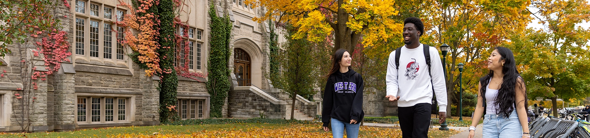 Students walking on campus in the fall